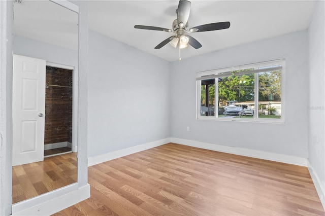 empty room with light wood-style flooring, baseboards, and ceiling fan