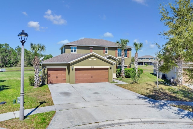 view of front of home with an attached garage, driveway, a front yard, and stucco siding