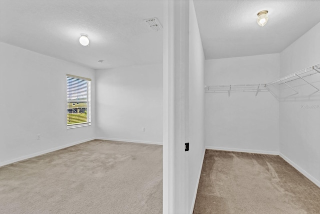 walk in closet featuring carpet and visible vents