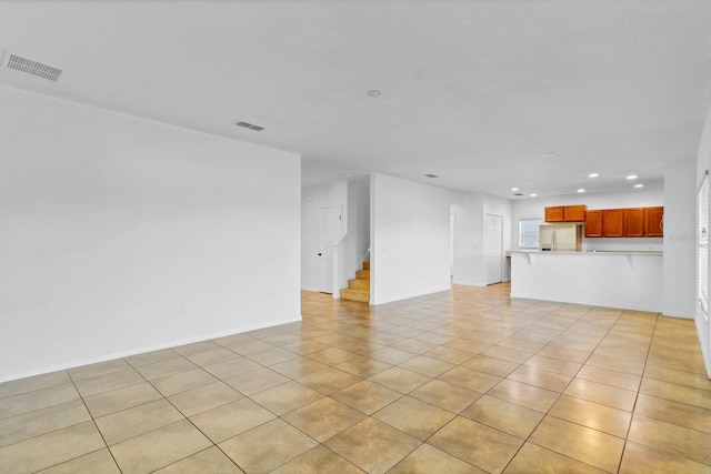 unfurnished living room with stairway, light tile patterned flooring, visible vents, and recessed lighting