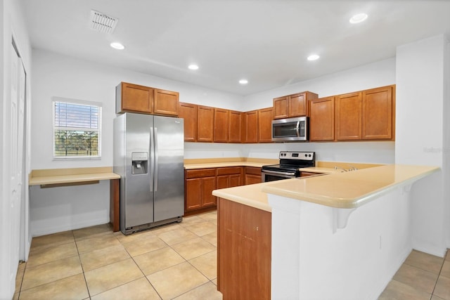 kitchen featuring recessed lighting, stainless steel appliances, a peninsula, visible vents, and light countertops