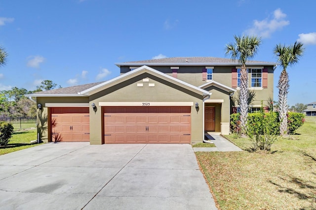 traditional-style home with driveway, a garage, stucco siding, fence, and a front yard