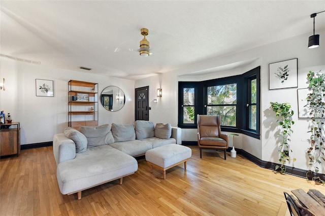 living room featuring light wood-style flooring and baseboards