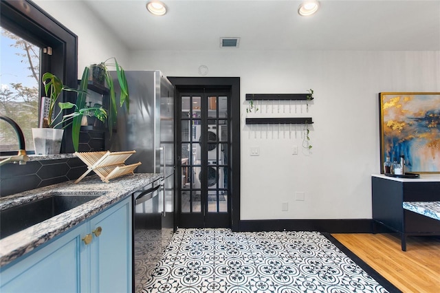 kitchen with visible vents, dishwasher, light stone counters, a sink, and recessed lighting