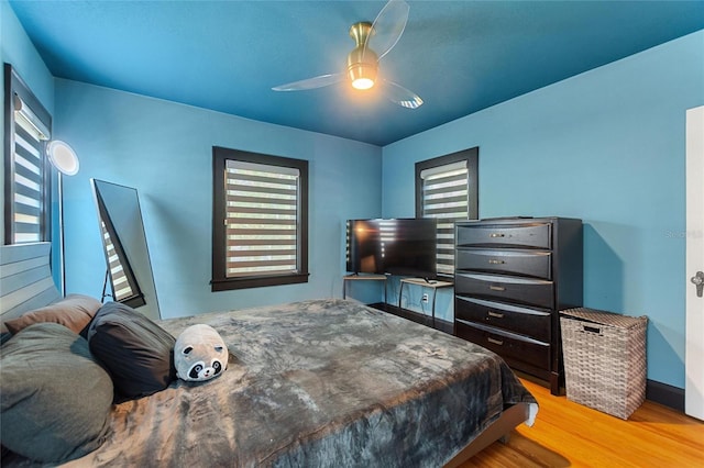 bedroom with ceiling fan and light wood-style flooring