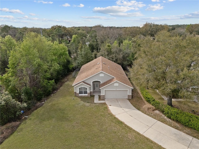 bird's eye view with a wooded view