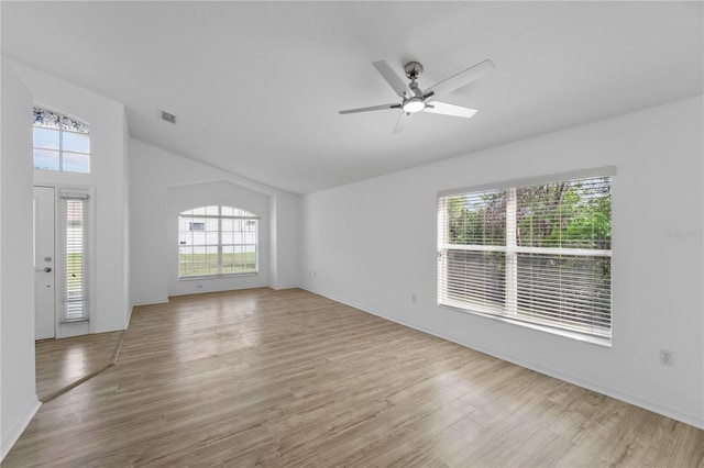 unfurnished living room with lofted ceiling, visible vents, ceiling fan, and wood finished floors