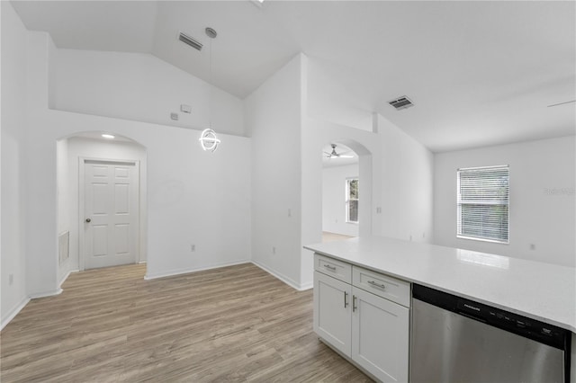 kitchen featuring arched walkways, light wood finished floors, light countertops, visible vents, and dishwasher