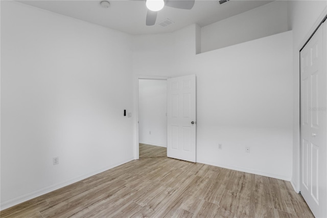 unfurnished bedroom featuring a closet, ceiling fan, baseboards, and wood finished floors