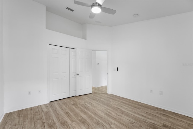 unfurnished bedroom with ceiling fan, visible vents, baseboards, a closet, and light wood-type flooring