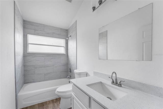 full bathroom featuring toilet, bathtub / shower combination, wood finished floors, and vanity