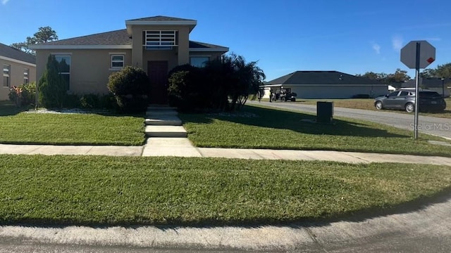 view of front of property with a front lawn and stucco siding