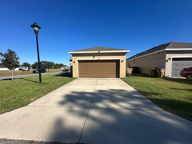 view of front of house featuring a front yard, roof with shingles, driveway, and stucco siding