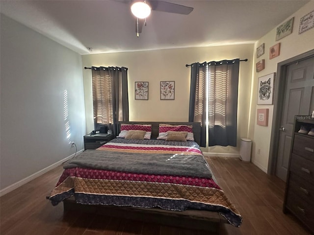 bedroom with a ceiling fan, baseboards, and wood finished floors