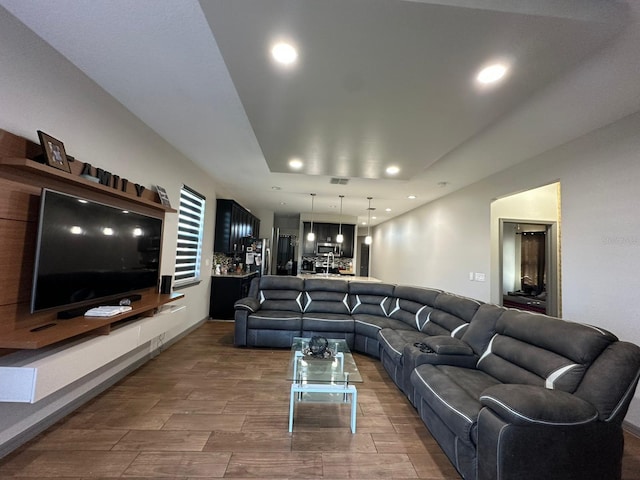 living room with wood tiled floor, visible vents, and recessed lighting