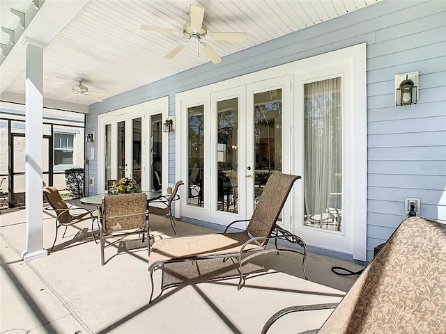 sunroom featuring ceiling fan and french doors