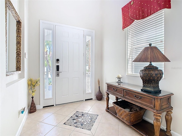 entrance foyer with baseboards and tile patterned floors