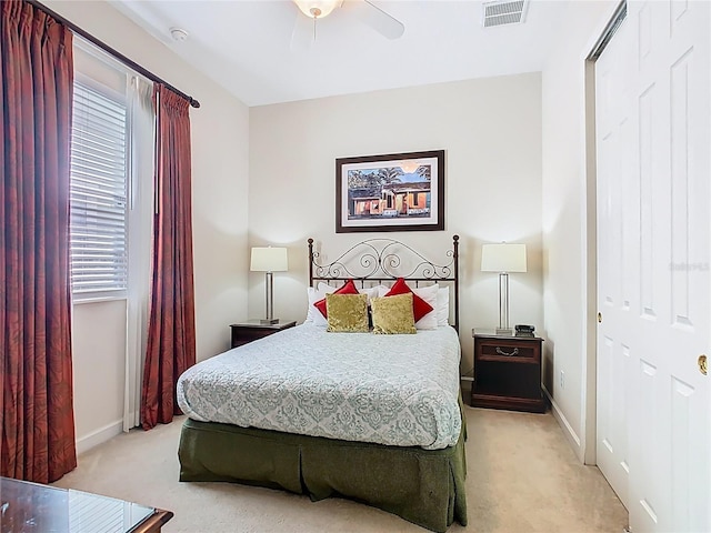 bedroom with light carpet, baseboards, visible vents, and ceiling fan