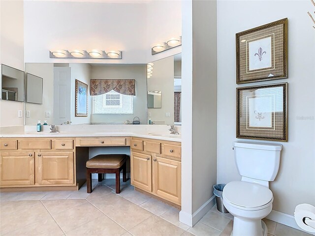 full bath featuring a sink, tile patterned flooring, toilet, and baseboards