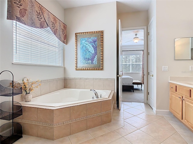 ensuite bathroom featuring ensuite bathroom, vanity, tile patterned flooring, and a bath