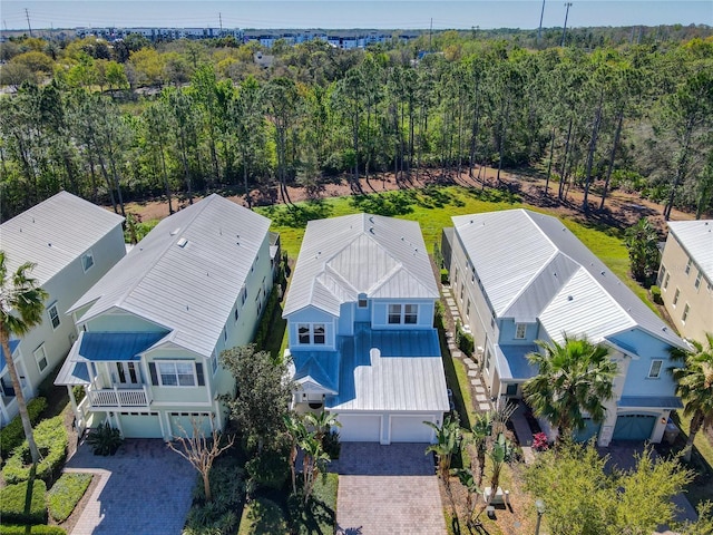 drone / aerial view with a forest view and a residential view