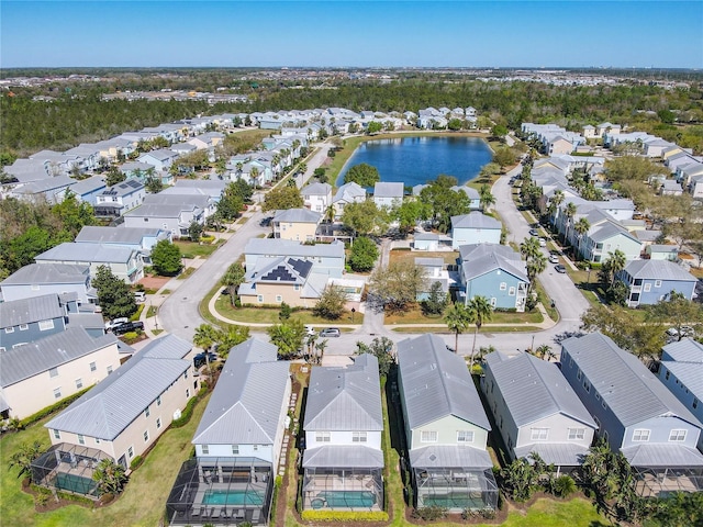 drone / aerial view with a residential view and a water view