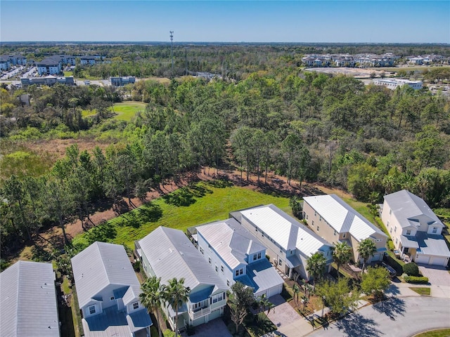 aerial view featuring a forest view and a residential view