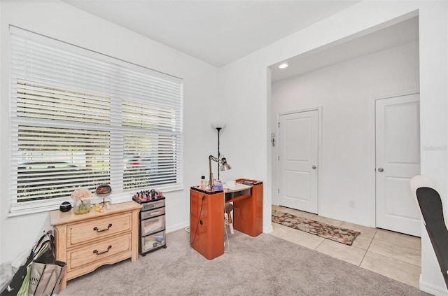 office area with light tile patterned flooring and light carpet