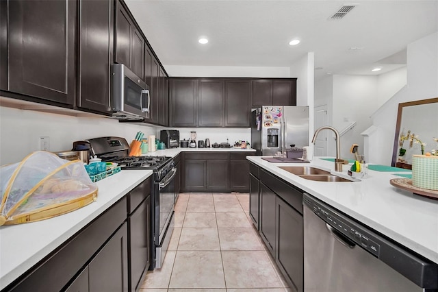 kitchen with visible vents, light countertops, light tile patterned floors, appliances with stainless steel finishes, and a sink