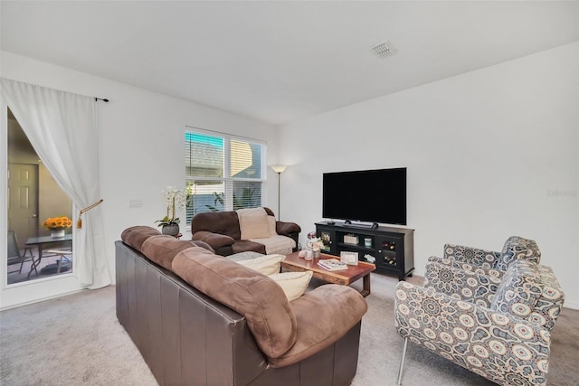 living room featuring visible vents and light carpet