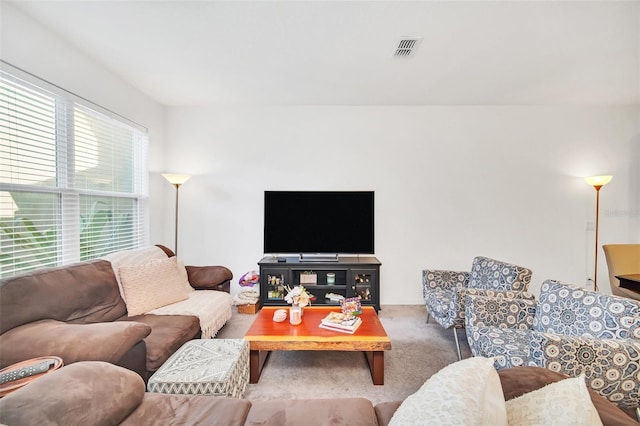 living room featuring visible vents and carpet floors