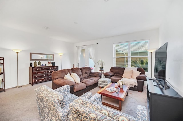 living room with baseboards and light carpet