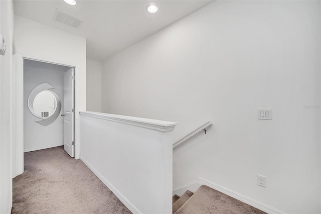 hall with visible vents, baseboards, an upstairs landing, carpet flooring, and recessed lighting