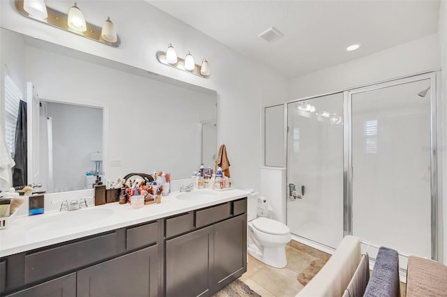 full bath featuring a sink, toilet, a stall shower, and tile patterned flooring