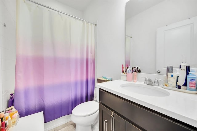 bathroom featuring vanity, toilet, and shower / tub combo with curtain