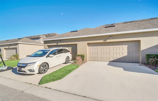 exterior space with a shingled roof, a garage, driveway, and stucco siding