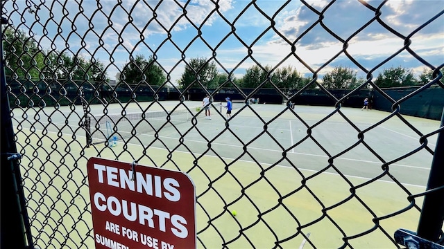 view of tennis court featuring fence