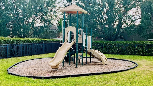 community playground with a yard and fence