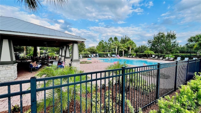 pool with a gazebo, a patio area, and fence