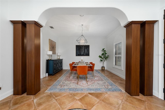 dining space featuring visible vents, arched walkways, and light tile patterned flooring