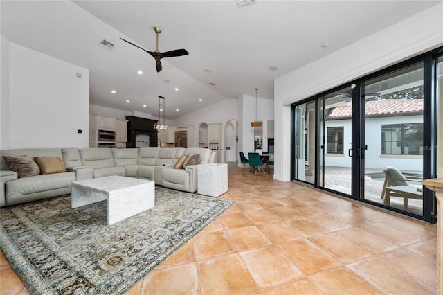 living area with arched walkways, lofted ceiling, recessed lighting, visible vents, and a ceiling fan