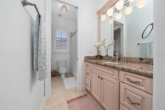 bathroom featuring a shower with curtain, visible vents, toilet, vanity, and tile patterned flooring