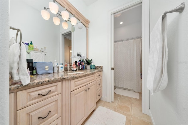 bathroom featuring curtained shower, vanity, and tile patterned floors