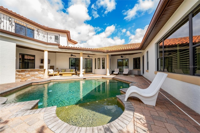 pool featuring a patio area, ceiling fan, and outdoor lounge area