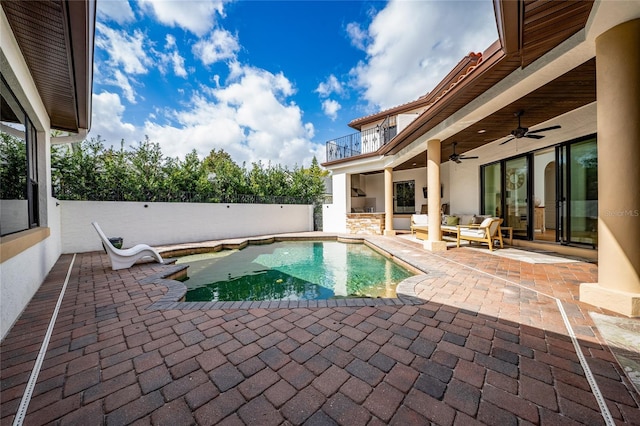 view of pool featuring an outdoor hangout area, fence, a ceiling fan, a fenced in pool, and a patio area