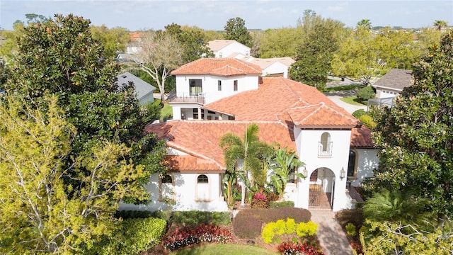 mediterranean / spanish house featuring stucco siding and a tiled roof