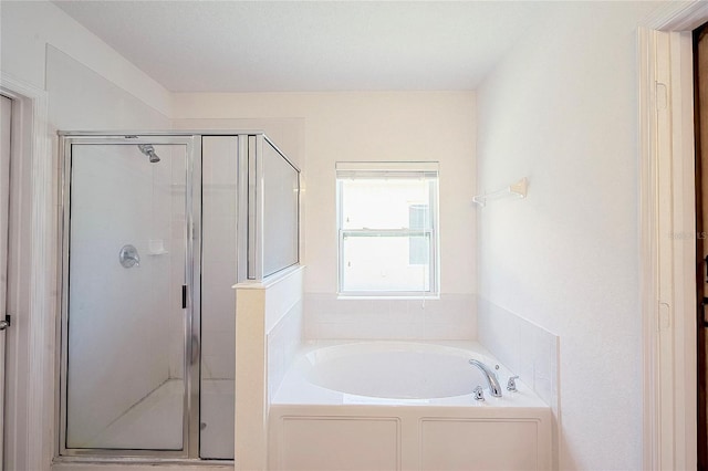 full bath featuring a garden tub and a shower stall