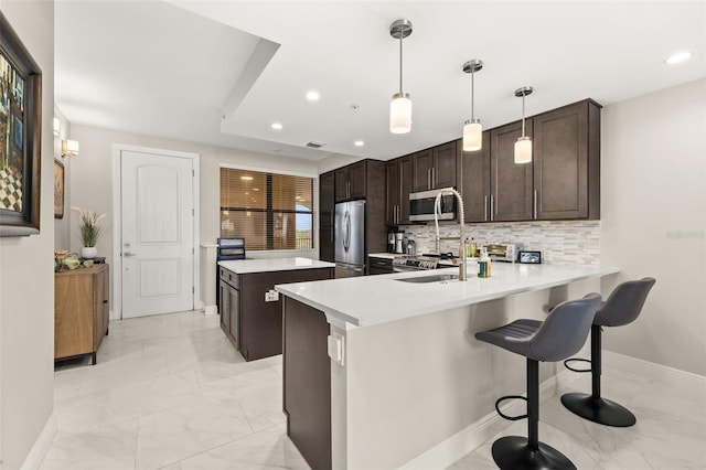 kitchen with marble finish floor, stainless steel appliances, dark brown cabinets, and tasteful backsplash