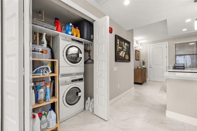 laundry room with laundry area, baseboards, stacked washer / drying machine, marble finish floor, and recessed lighting