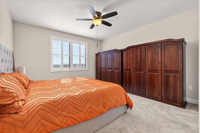 bedroom featuring carpet floors, a ceiling fan, and baseboards